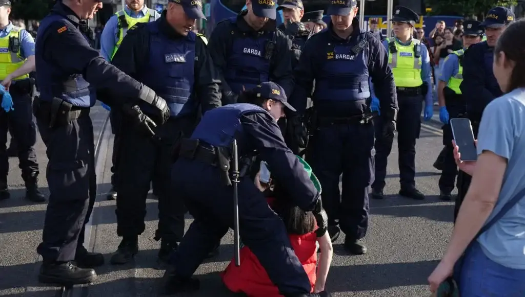 Gardaí remove a protester from O'Connell Bridge, during an anti-immigration protest. Photo credit: Brian Lawless/PA Wire